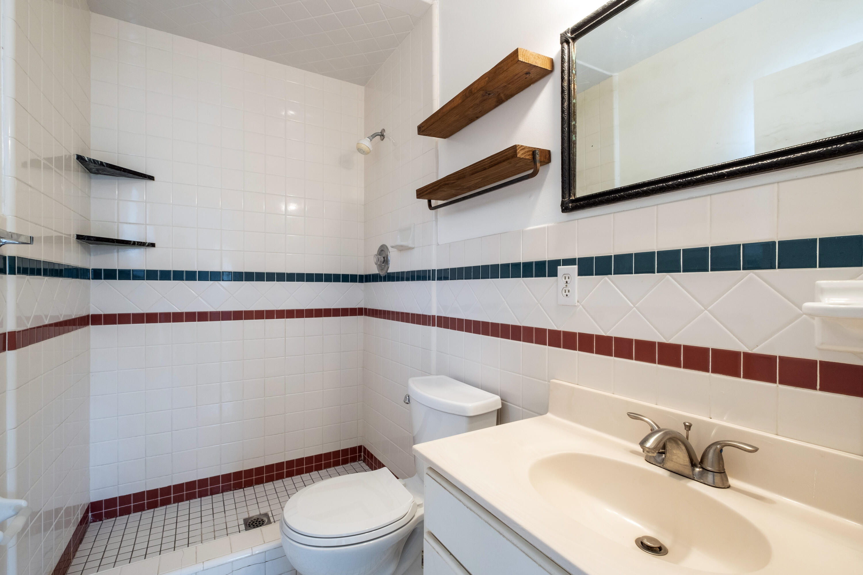 2530 Murrell Road Santa Barbara, CA 93109 - Photo 10 of 19 a bathroom with a sink a toilet and a mirror