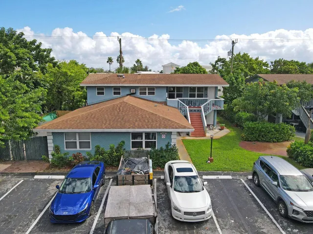 an aerial view of a house with swimming pool garden and patio