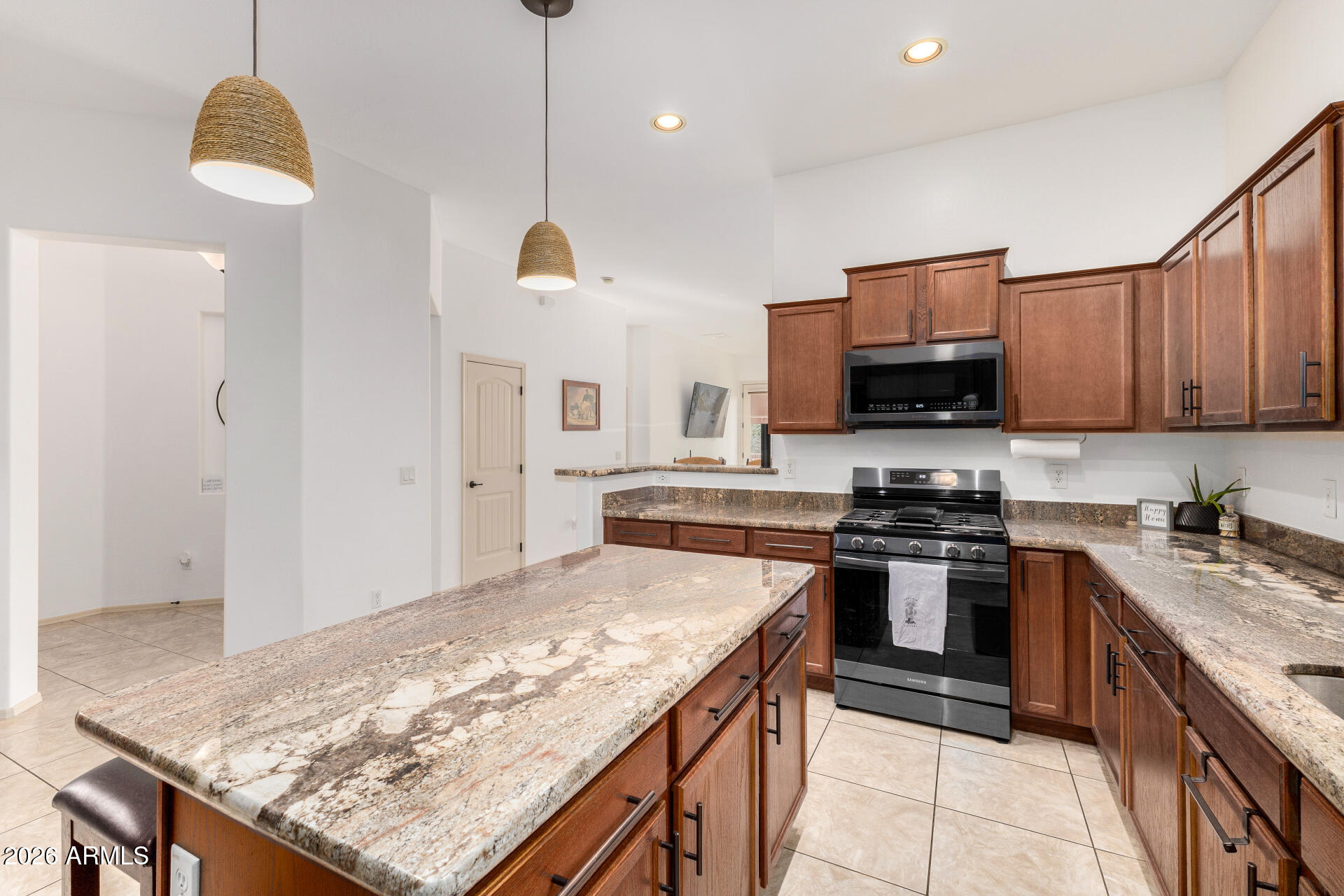 6202 East McKellips Road, Unit 189 Mesa, AZ 85215 - Photo 16 of 33 a kitchen with stainless steel appliances granite countertop a sink stove and refrigerator