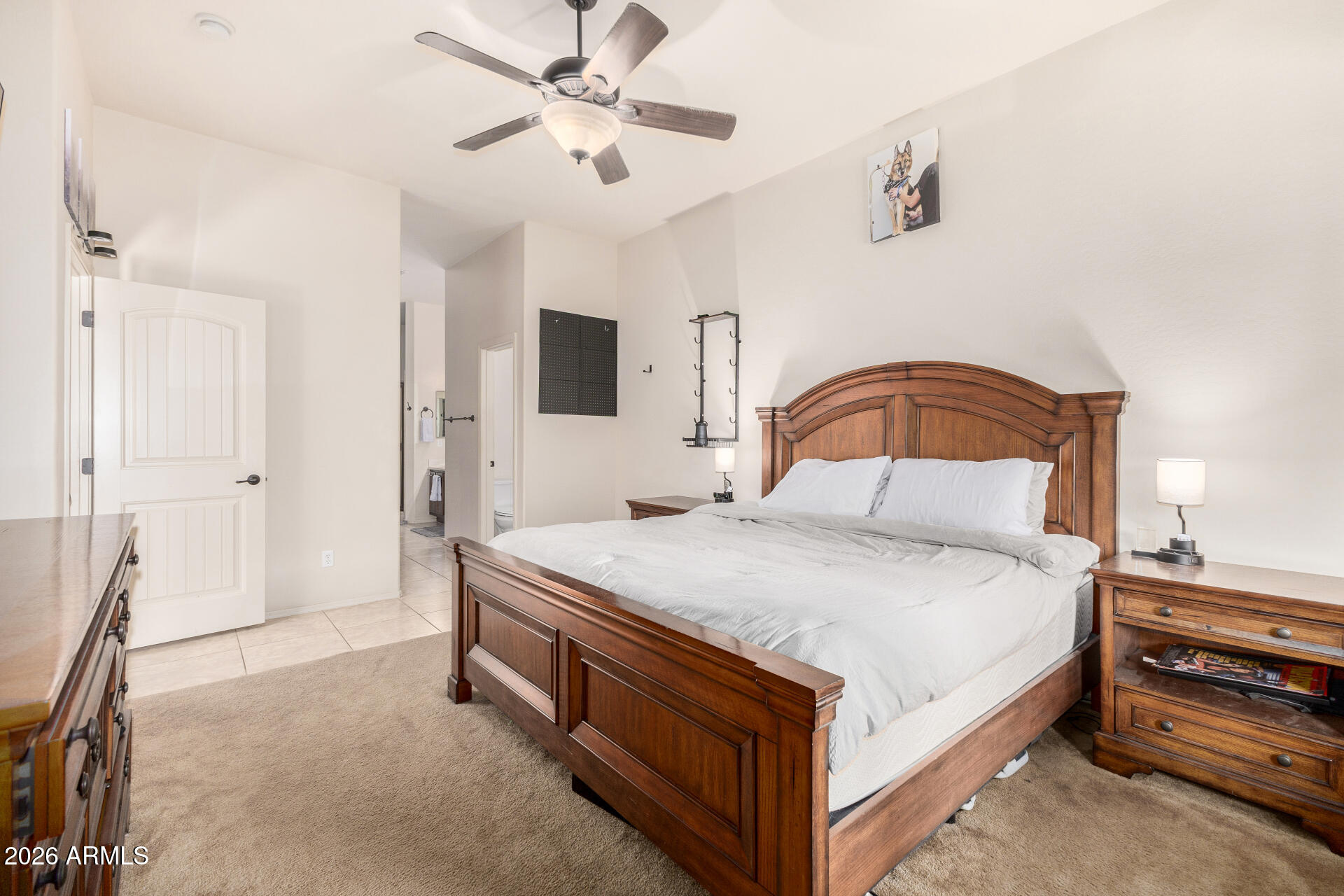 6202 East McKellips Road, Unit 189 Mesa, AZ 85215 - Photo 19 of 33 a bedroom with a bed and a chandelier