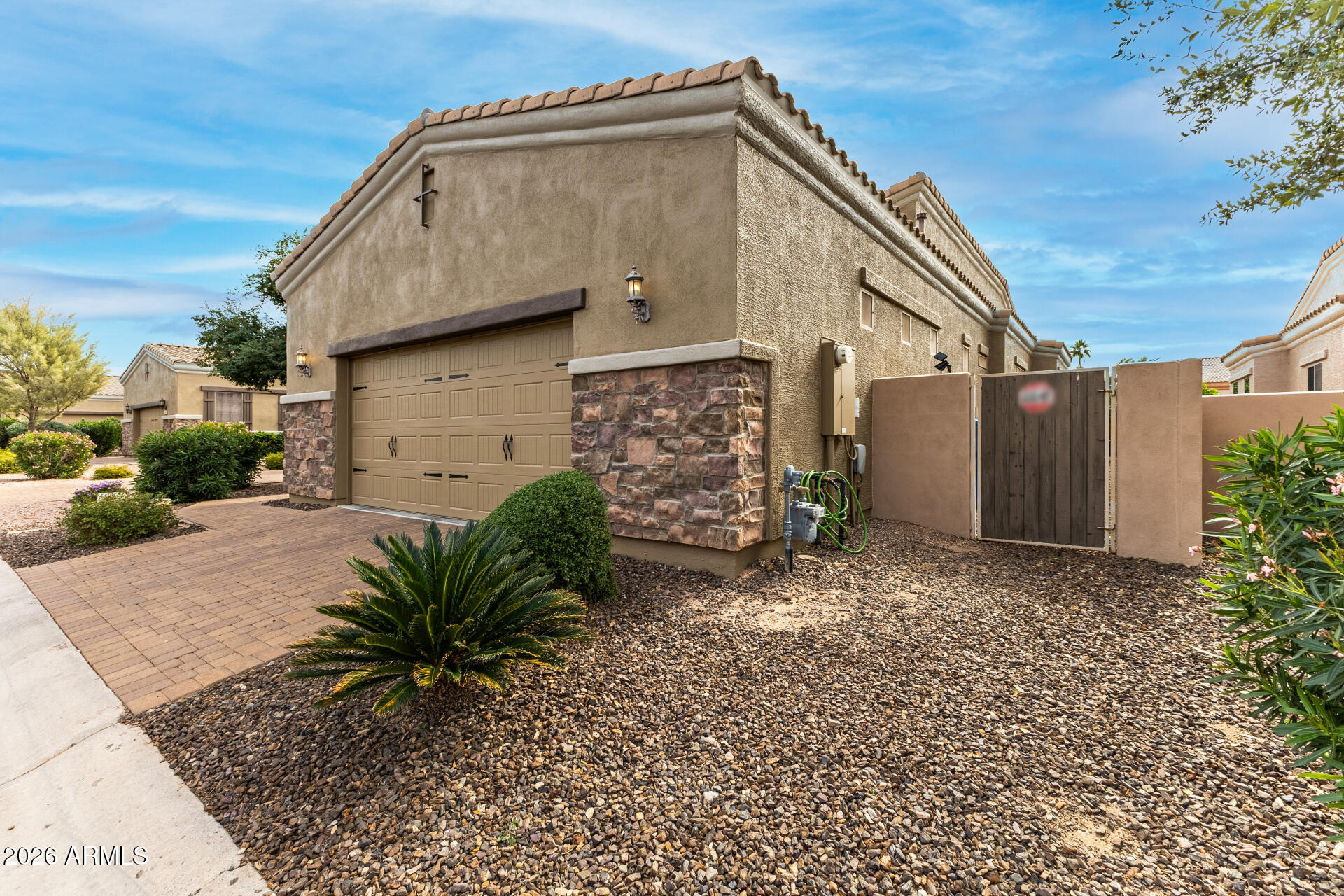 6202 East McKellips Road, Unit 189 Mesa, AZ 85215 - Photo 3 of 33 a backyard of a house with potted plants