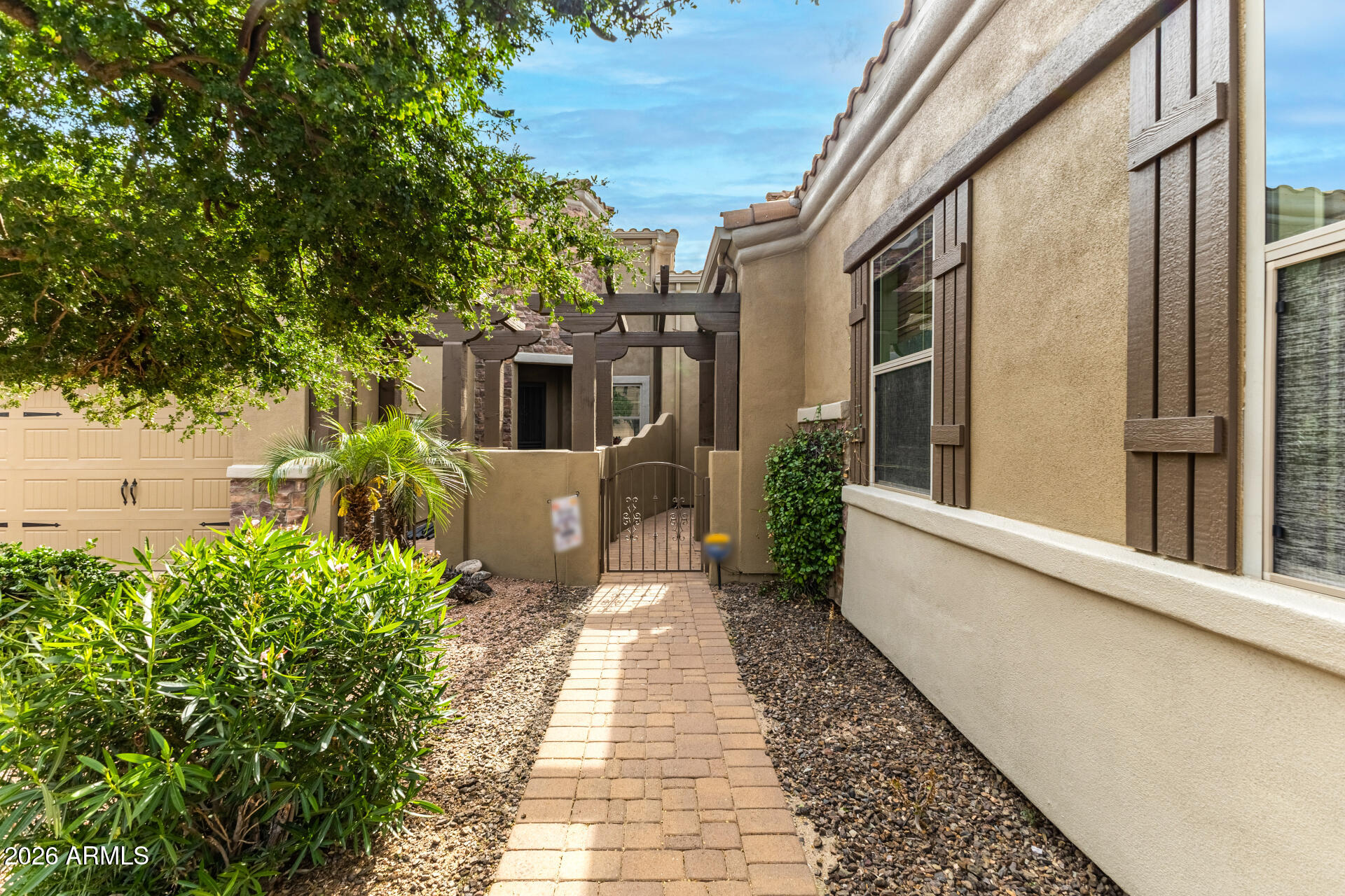 6202 East McKellips Road, Unit 189 Mesa, AZ 85215 - Photo 7 of 33 a front view of a house with a garden