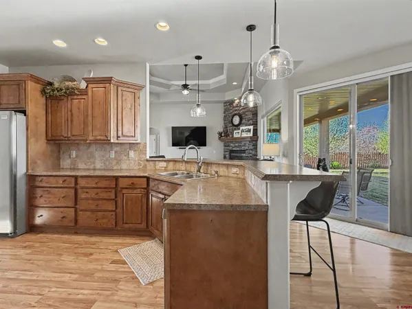 a kitchen with stainless steel appliances granite countertop a sink stove and a refrigerator