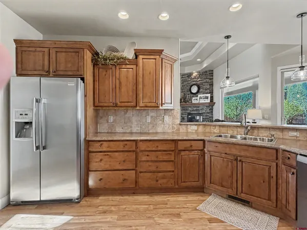 a kitchen with stainless steel appliances granite countertop a refrigerator and a sink