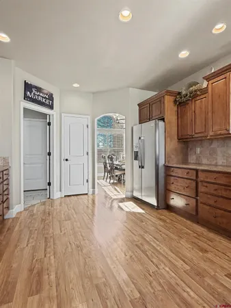 a view of a kitchen with a sink and a refrigerator
