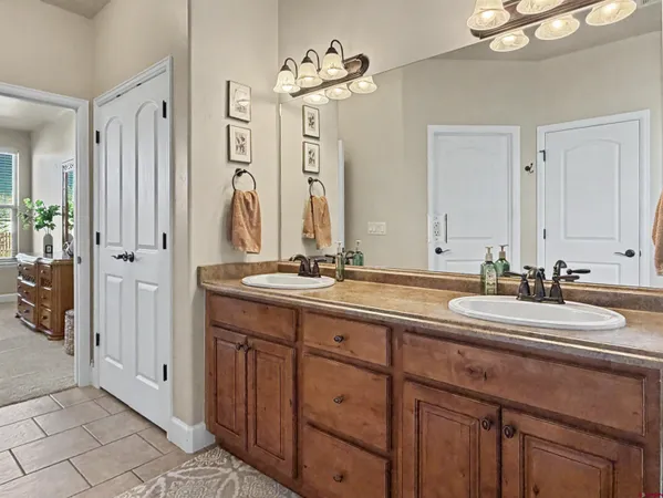 a bathroom with a double vanity sink and a mirror