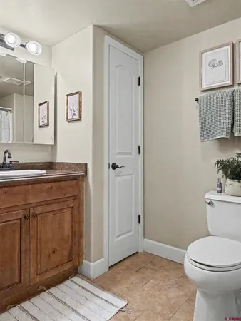 a bathroom with a toilet a sink and mirror