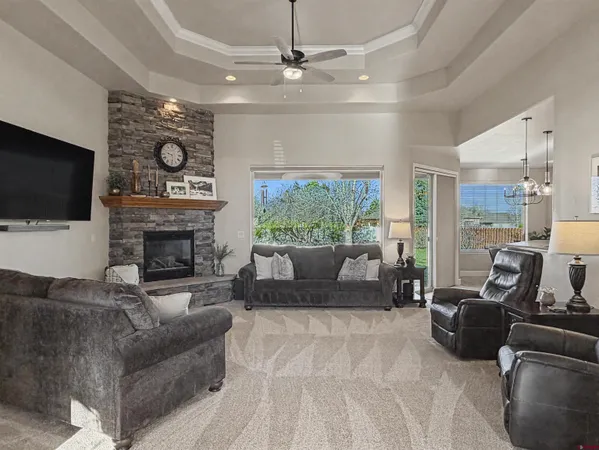 a living room with furniture a fireplace and a flat screen tv