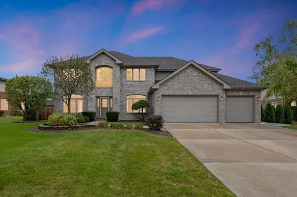a front view of a house with a yard and garage