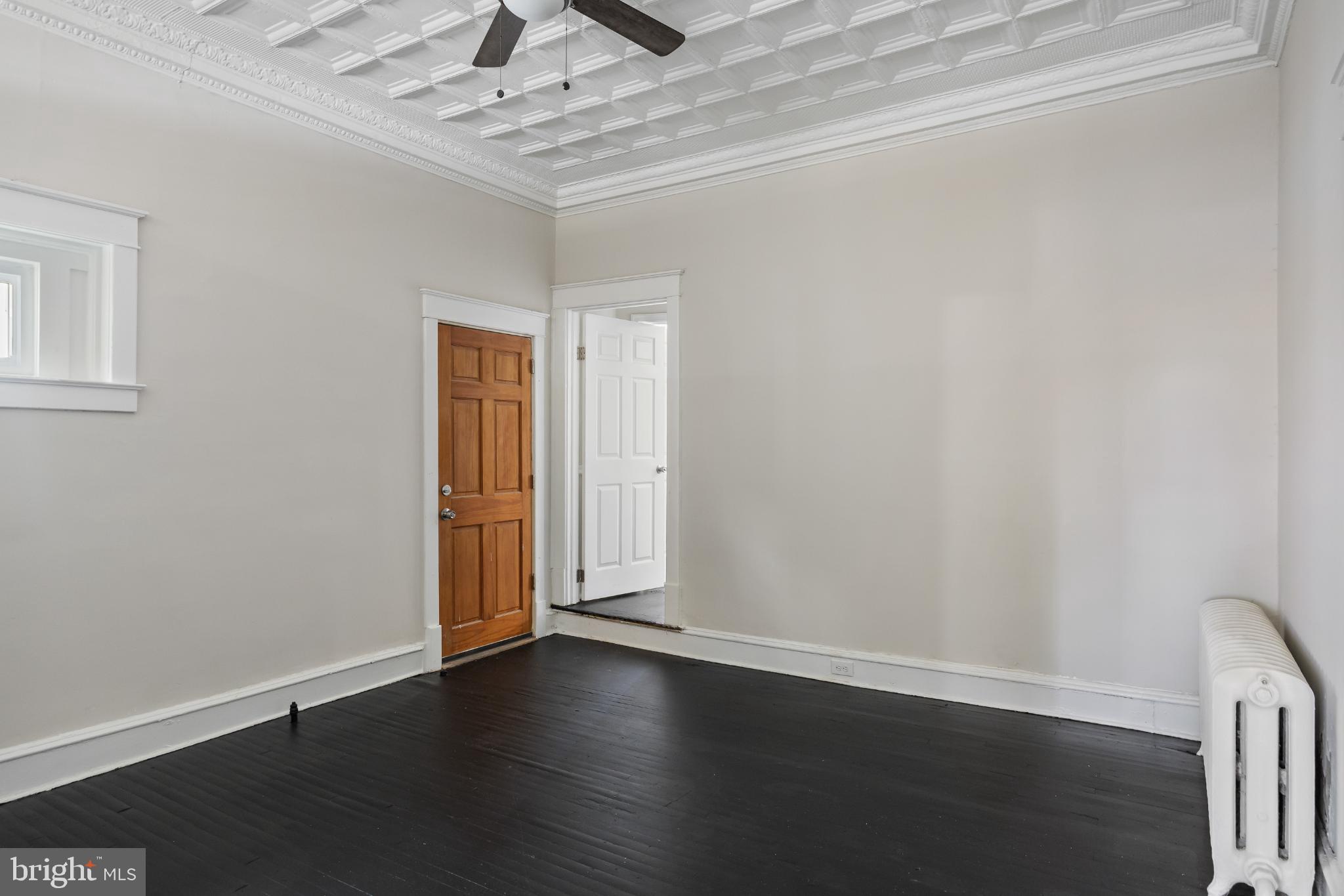 2003 Edgmont Avenue Chester, PA 19013 - Photo 11 of 40 a view of an empty room with wooden floor and a window