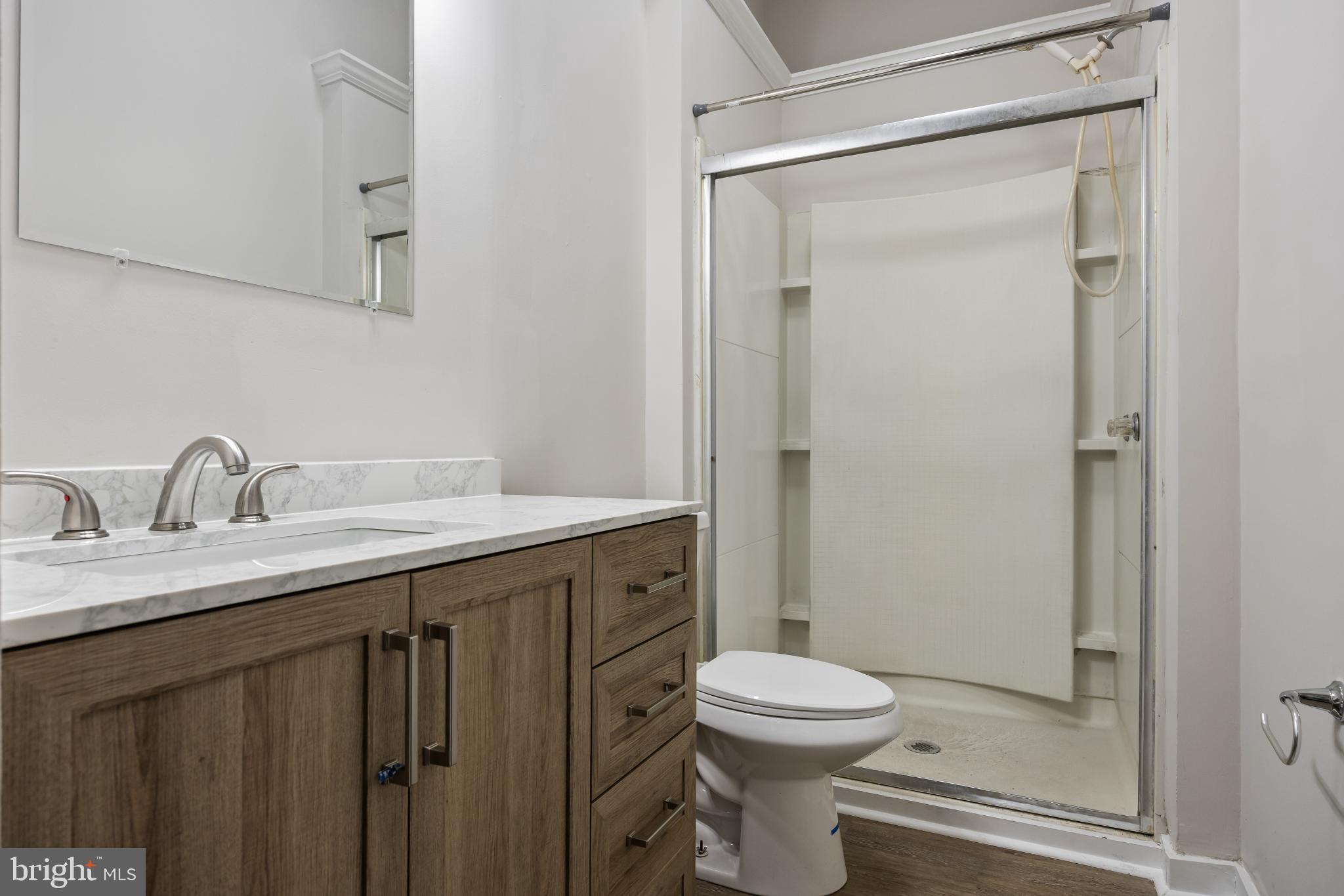 2003 Edgmont Avenue Chester, PA 19013 - Photo 13 of 40 a bathroom with a granite countertop sink toilet and shower