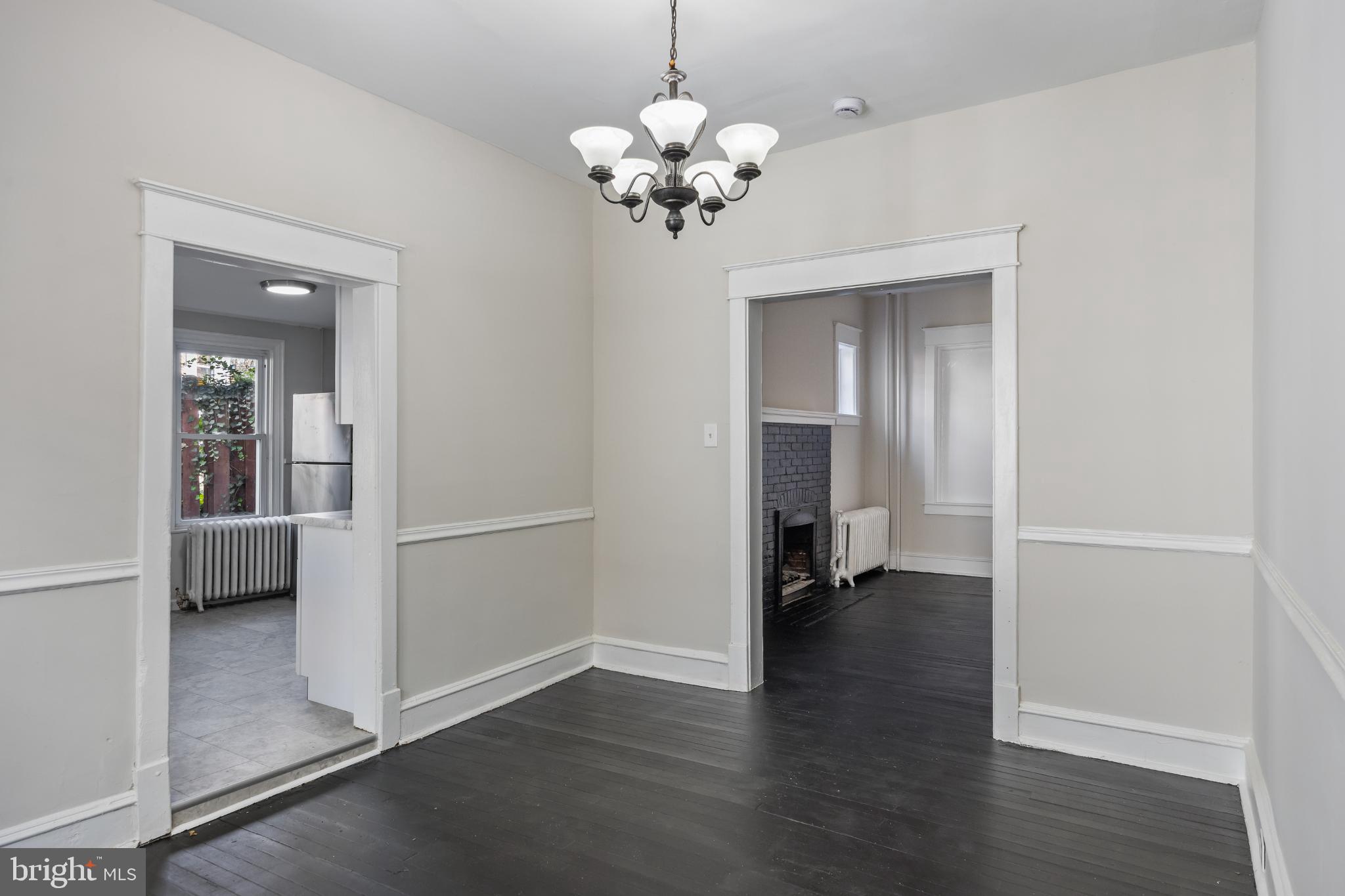 2003 Edgmont Avenue Chester, PA 19013 - Photo 19 of 40 a view of a room with wooden floor and a chandelier