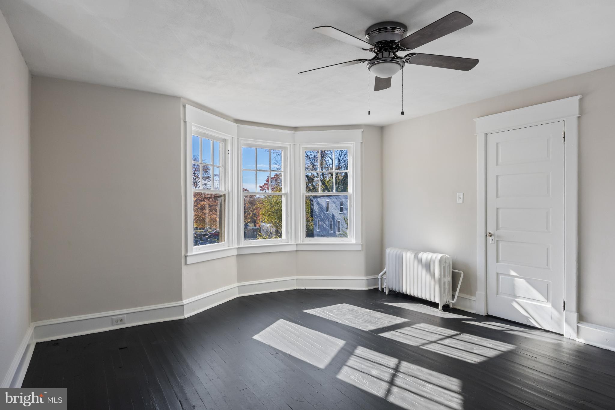 2003 Edgmont Avenue Chester, PA 19013 - Photo 26 of 40 a view of an empty room with a window and wooden floor