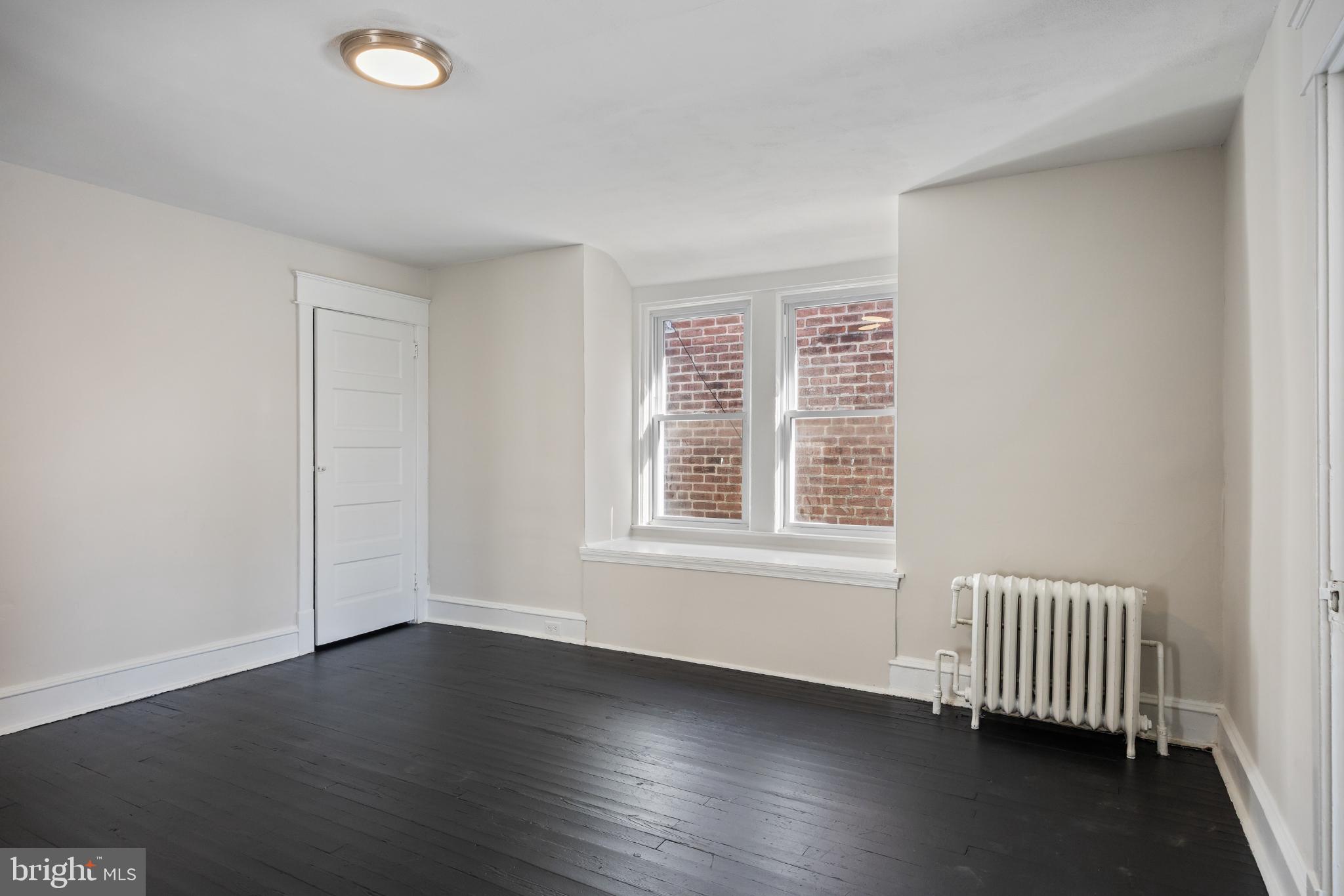 2003 Edgmont Avenue Chester, PA 19013 - Photo 31 of 40 an empty room with wooden floor and windows