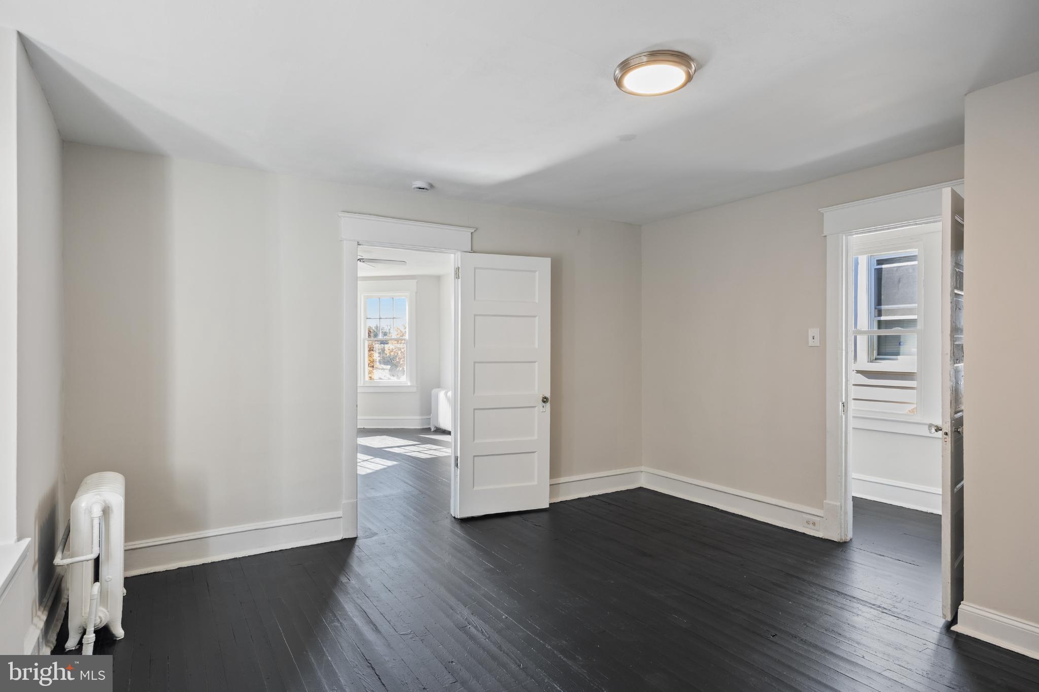 2003 Edgmont Avenue Chester, PA 19013 - Photo 32 of 40 a view of an empty room with wooden floor and a window