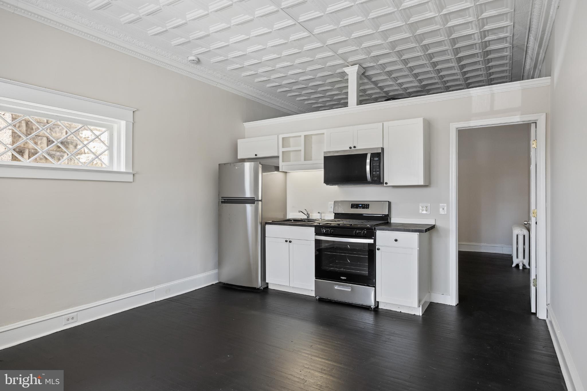 2003 Edgmont Avenue Chester, PA 19013 - Photo 6 of 40 a kitchen with stainless steel appliances a stove top oven a sink and a microwave