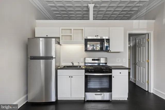 a kitchen with stainless steel appliances a refrigerator sink and stove