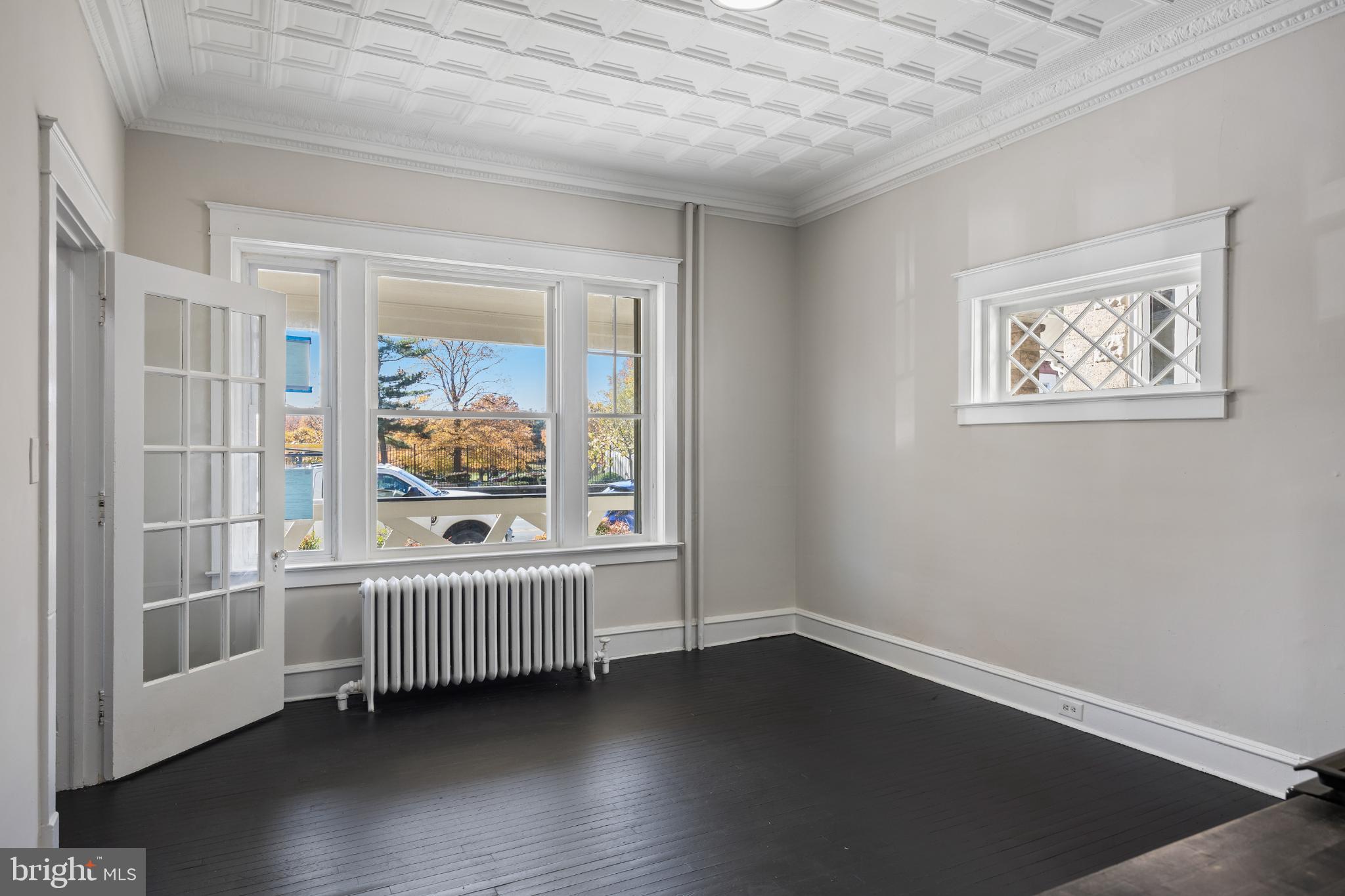 2003 Edgmont Avenue Chester, PA 19013 - Photo 10 of 40 an empty room with wooden floor and windows
