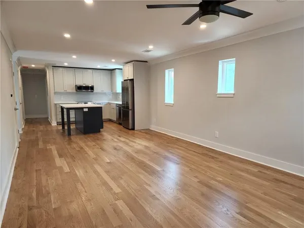 a large kitchen with stainless steel appliances kitchen island a large counter space a sink and a stove