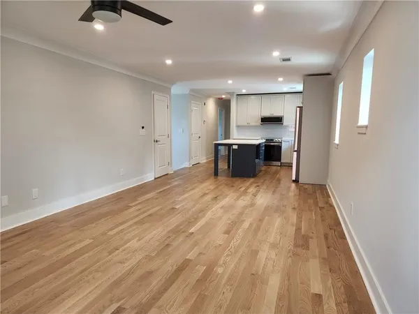 a view of kitchen with sink and refrigerator