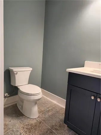 a white toilet sitting next to a bathroom sink