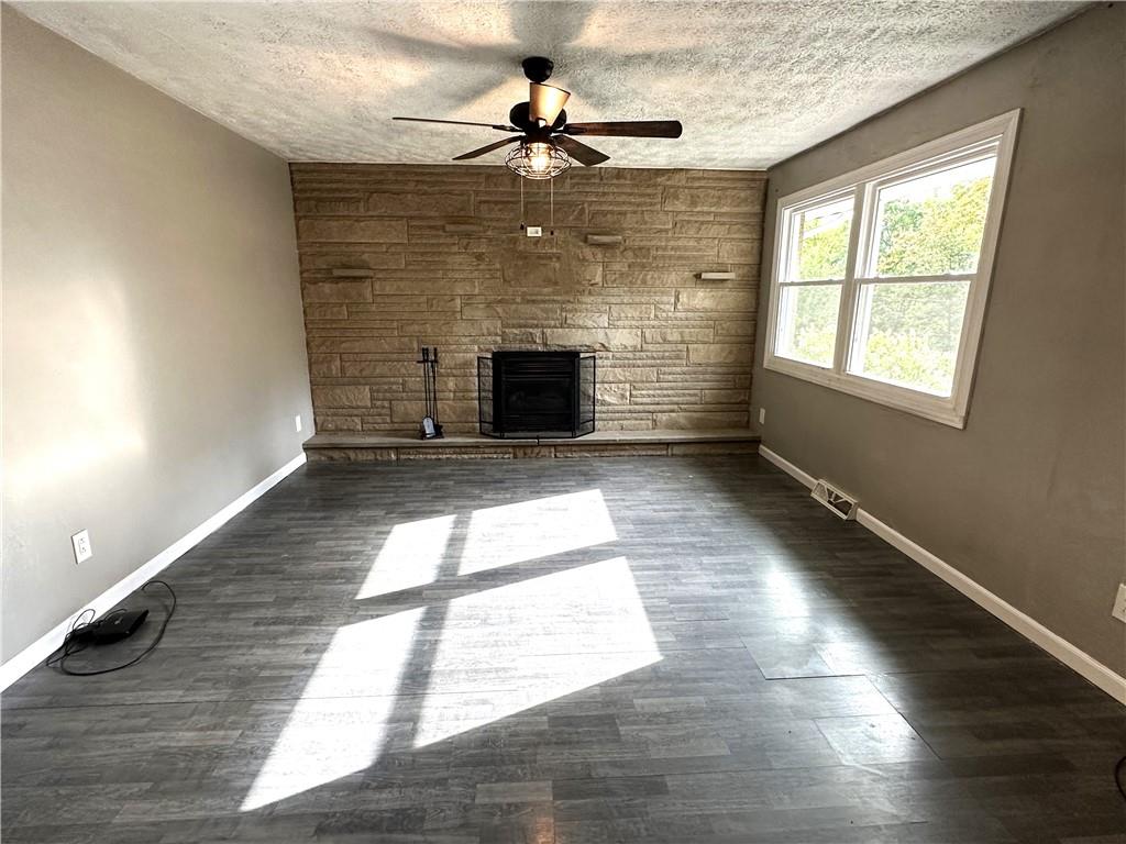 916 Atlasburg Road Burgettstown, PA 15021 - Photo 11 of 28 an empty room with wooden floor a chandelier fan and windows