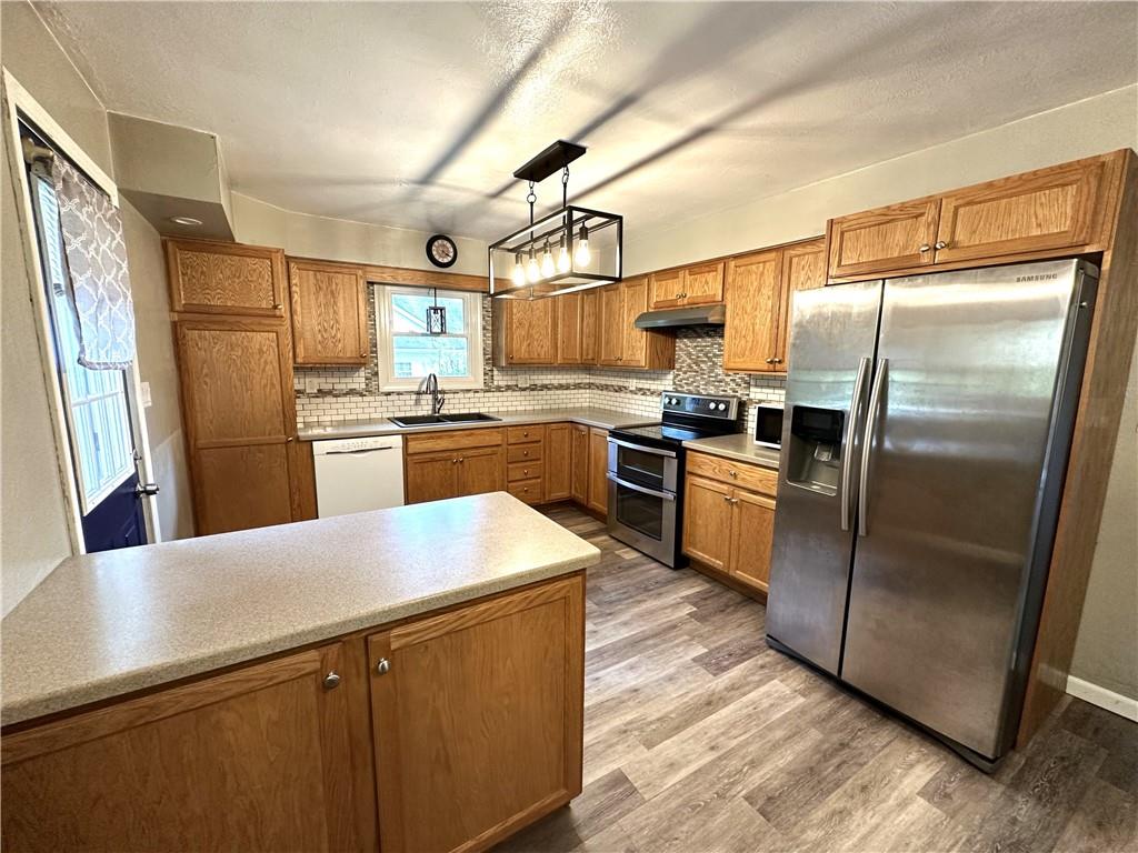 916 Atlasburg Road Burgettstown, PA 15021 - Photo 9 of 28 a kitchen with stainless steel appliances granite countertop a refrigerator a stove and a sink