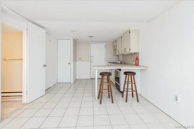 a kitchen with stainless steel appliances a table and chairs