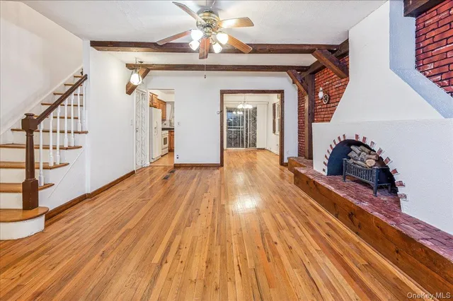 a view of a room with wooden floor and stairs