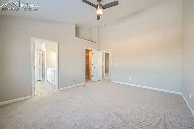 an empty room with a ceiling fan