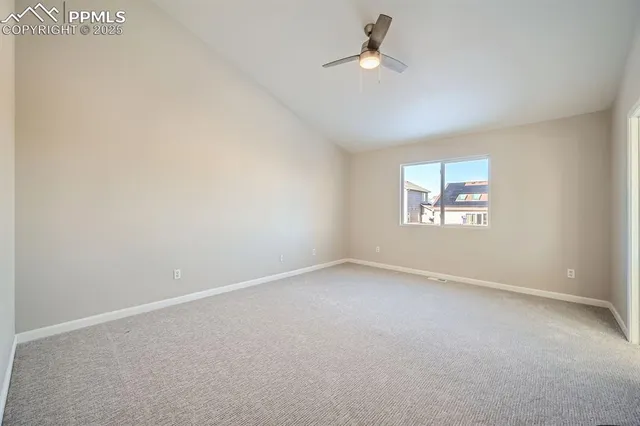 an empty room with windows and ceiling fan
