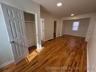 10 Hill Street, Unit 1 New Canaan, CT 06840 - Photo 2 of 10 a view of a room with wooden floor and stairs