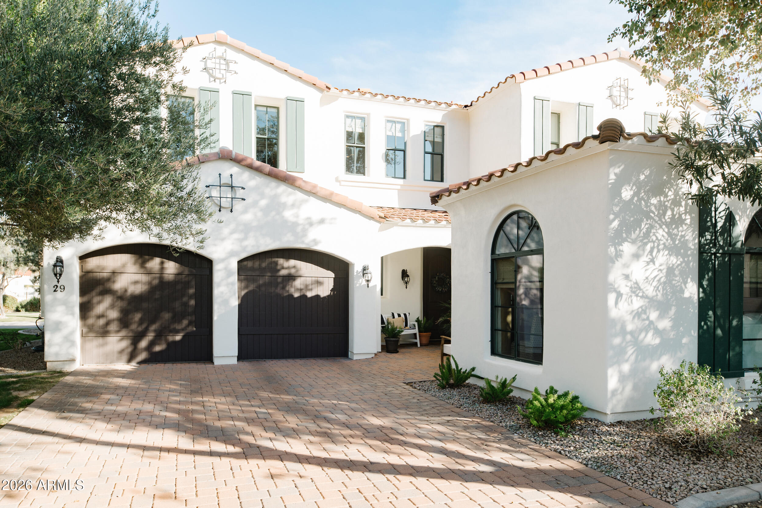 a front view of a house with a garden