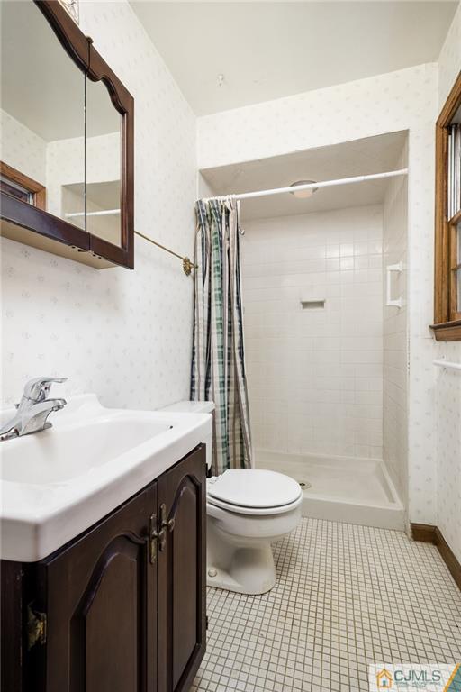 21 Station Road Cranbury, NJ 08512 - Photo 14 of 25 a bathroom with a sink a toilet a mirror and shower