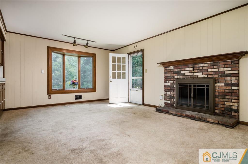 21 Station Road Cranbury, NJ 08512 - Photo 8 of 25 an empty room with fireplace and windows