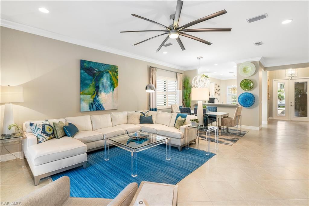 13628 Mandarin Circle Naples, FL 34109 - Photo 11 of 48 a living room with furniture and a large window