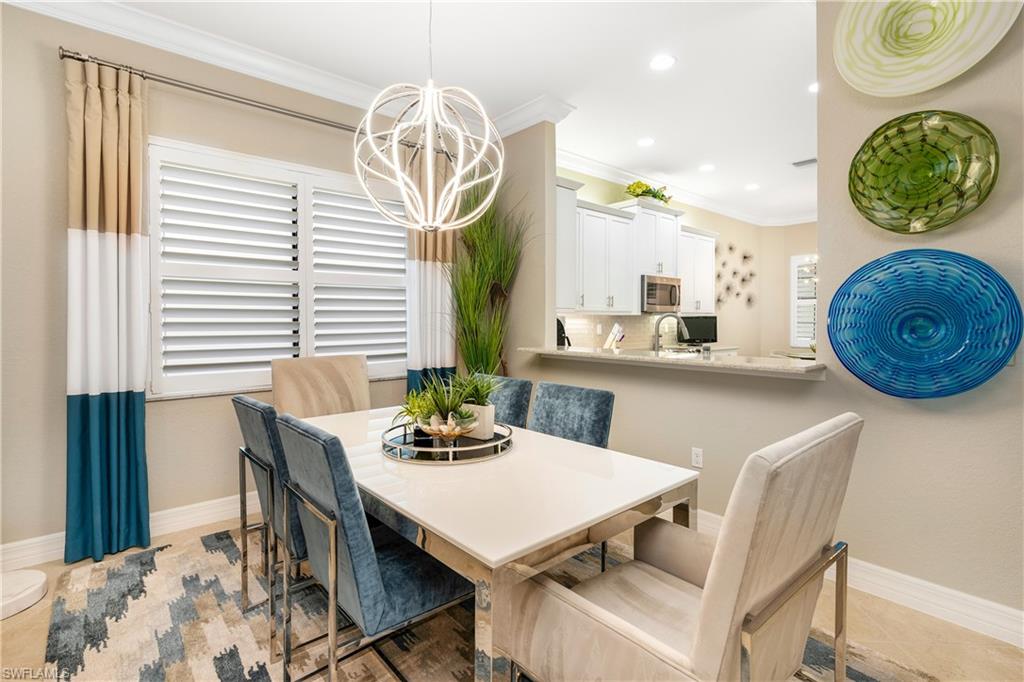 13628 Mandarin Circle Naples, FL 34109 - Photo 12 of 48 a view of a dining room with furniture and chandelier