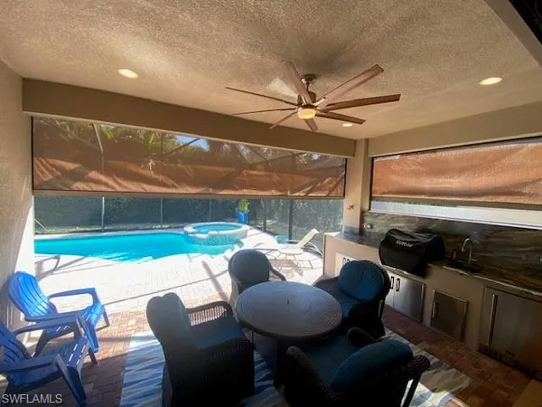 a view of a swimming pool with a yard and sitting area
