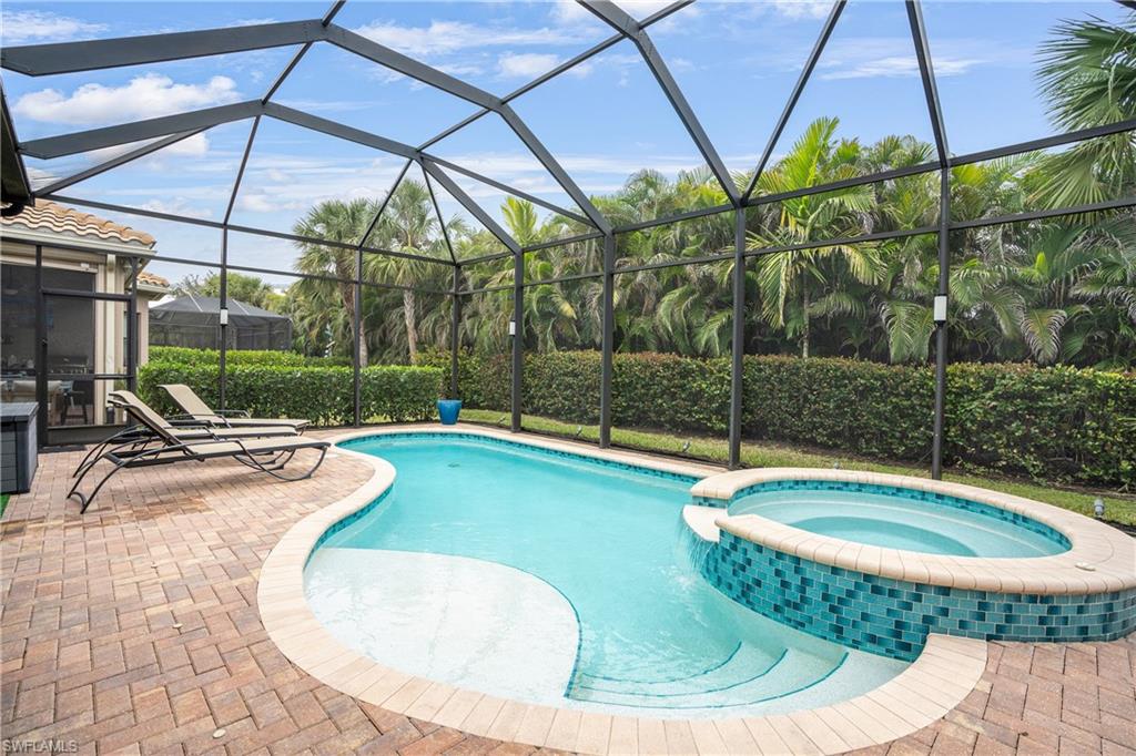 13628 Mandarin Circle Naples, FL 34109 - Photo 15 of 48 a view of a swimming pool with a yard and sitting area
