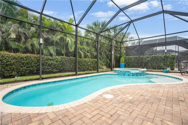 a swimming pool with outdoor seating and yard