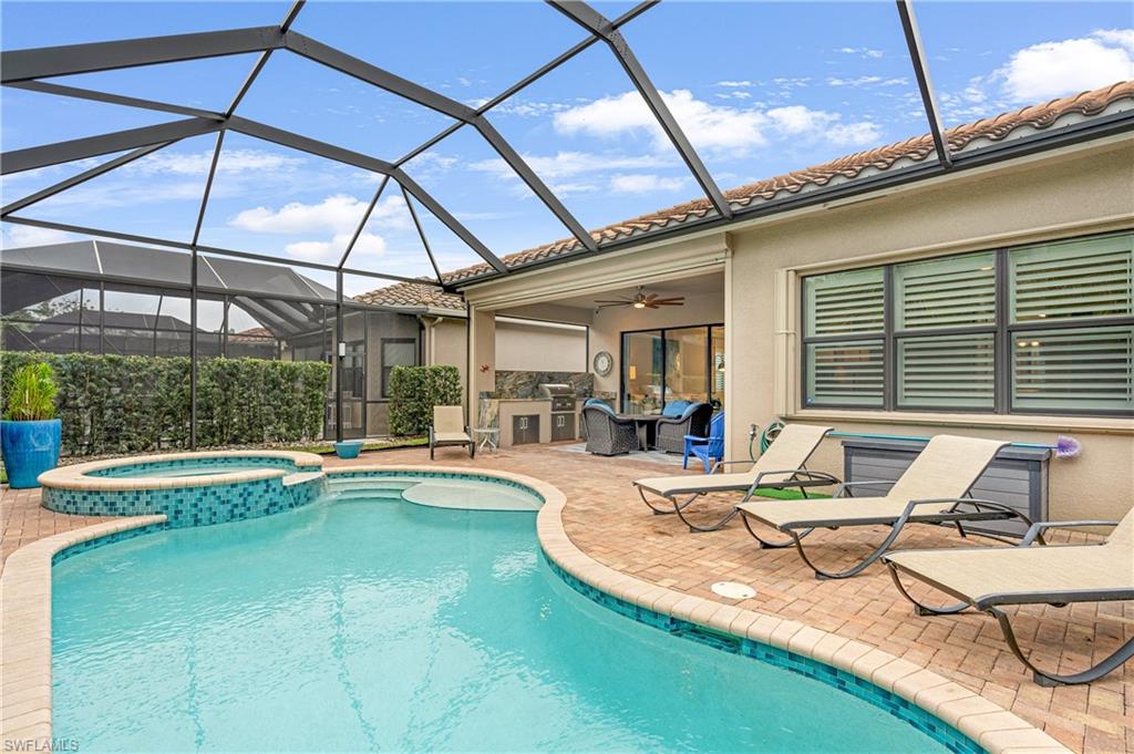 13628 Mandarin Circle Naples, FL 34109 - Photo 18 of 48 a view of a patio with swimming pool table and chairs