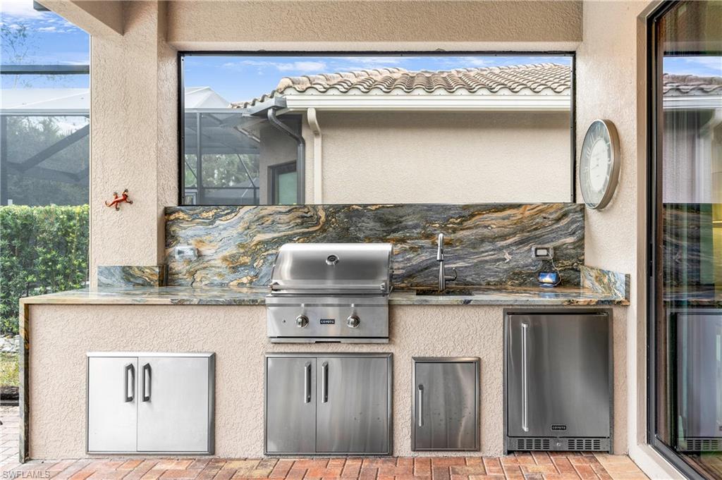13628 Mandarin Circle Naples, FL 34109 - Photo 20 of 48 a kitchen with a stove and a refrigerator