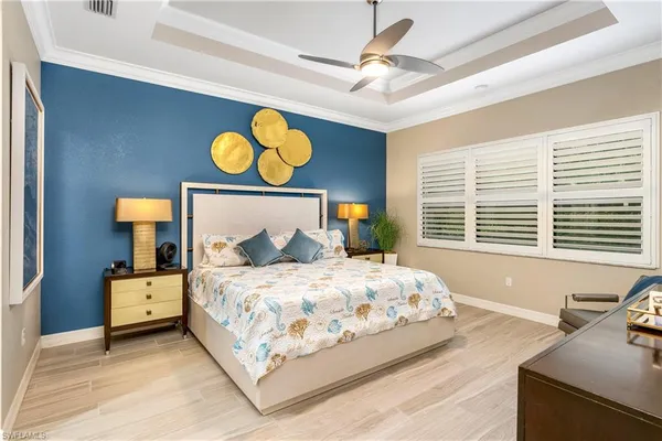 a bedroom with a bed and dresser with mirror