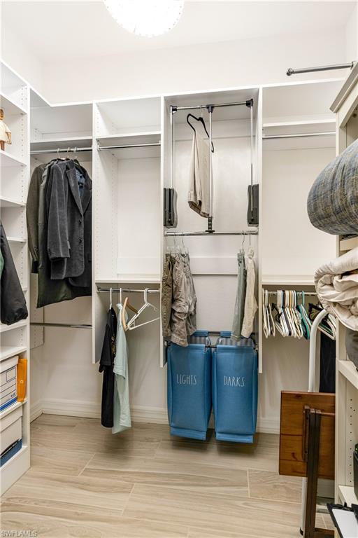 13628 Mandarin Circle Naples, FL 34109 - Photo 24 of 48 a view of walk in closet with clothes and shoes