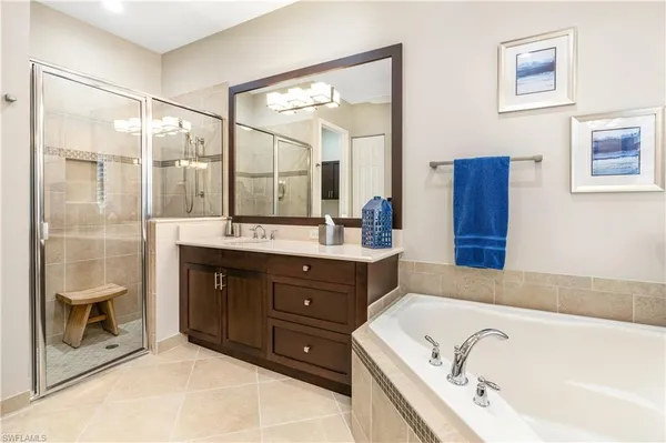 a bathroom with a bathtub sink and mirror