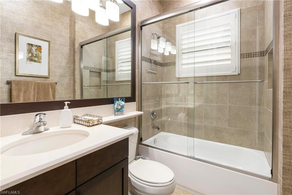 13628 Mandarin Circle Naples, FL 34109 - Photo 28 of 48 a bathroom with a sink a toilet and shower