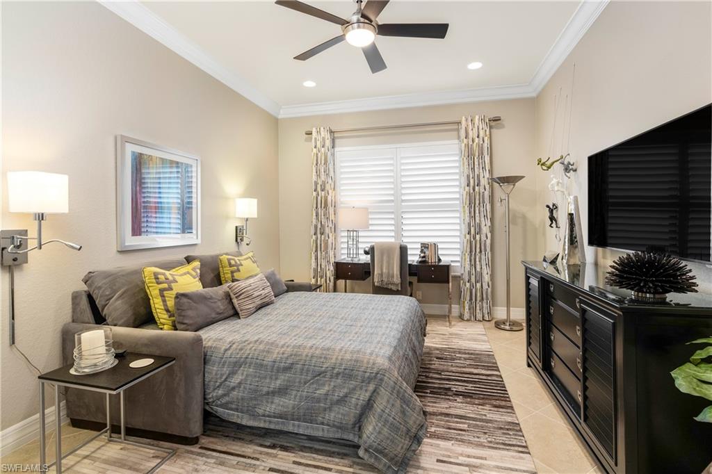 13628 Mandarin Circle Naples, FL 34109 - Photo 30 of 48 a bedroom with a bed and wooden floor