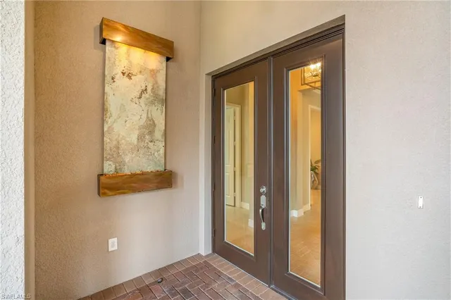 a view of a hallway with wooden floor and chandelier