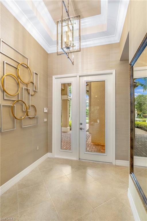 13628 Mandarin Circle Naples, FL 34109 - Photo 4 of 48 a view of a hallway with wooden floor and chandelier