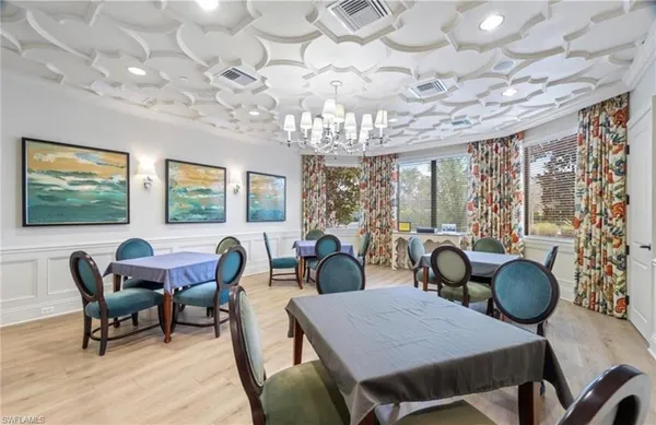 a room with pool table and glass windows
